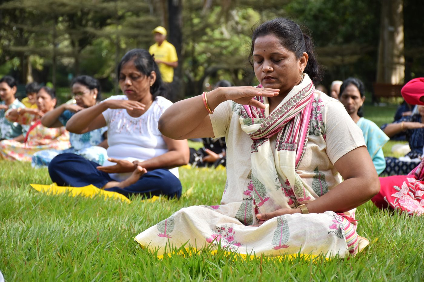 Practitioners seated in quiet meditation during a group session in India